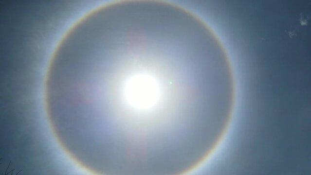 Rare Rainbow Circular Halo Around Sun Optical Phenomenon at Blue Day Light Sky