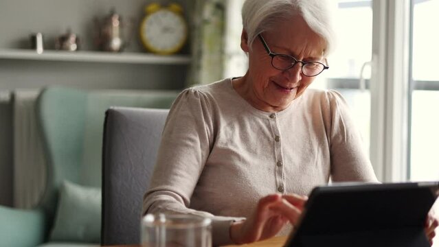 Senior woman using a digital tablet at home