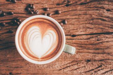 coffee latte art on wood table, relax time, cafe barista art top view.
