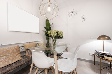 Glass dining table with floral decoration in a vacation rental apartment