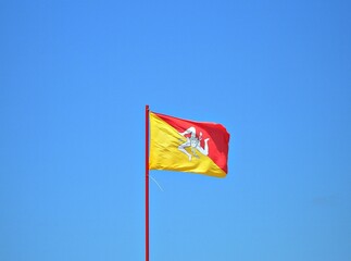 Italy, Sicily: Sicilian Flag in the blue Sky.