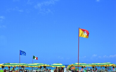 Italy, Sicily: Sicilian Flag in the blue Sky. - obrazy, fototapety, plakaty