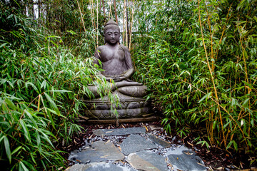 Flat stones path to Buddha statue in the garden