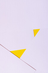 geometric background with lavender paper sheets and yellow triangles.