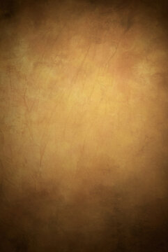 Warm colors painted fabric photography studio background with shades of yellow and brown with hints of pink.
