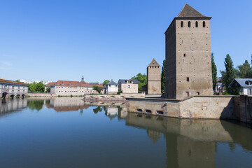 Fototapeta premium Strasbourg, France - May 22, 2017: .Covered bridge and Vauban dam over ILL Canal, Strasbourg, Alsace, Bas-Rhin Department, France
