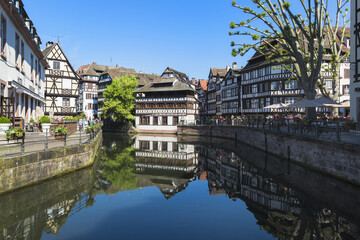 Fototapeta na wymiar Strasbourg, France - May 22, 2017: Tanners’ House and timbered houses along the ILL canal, Petite France District, Strasbourg, Alsace, Bas-Rhin Department, France