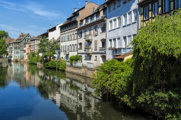 Fototapeta na wymiar Timbered Houses reflecting in the ILL canal along the riverbank of the Petite France, Strasbourg, Alsace, Bas-Rhin Department, France