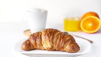 Continental breakfast concept with croissant, coffee, orange juice