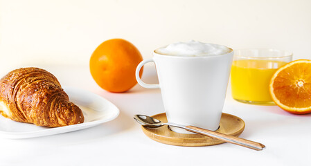 Breakfast concept with coffee, orange juice and croissant