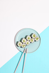 Classic japanese sushi with fresh cucumber - kappa maki. Kappa hosomaki in minimal style. Simple maki sushi with cucumber. Vegan sushi roll.