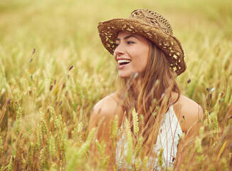 Getting away from it all. Cropped shot of a young woman in a wheat field.