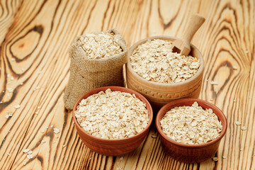 Оatmeal in bowls and bags on a wooden background. High quality photo