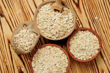 Оatmeal in bowls and bags on a wooden background. High quality photo