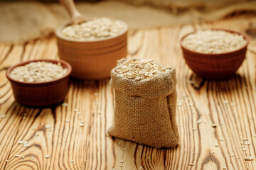 Оatmeal in bowls and bags on a wooden background. High quality photo