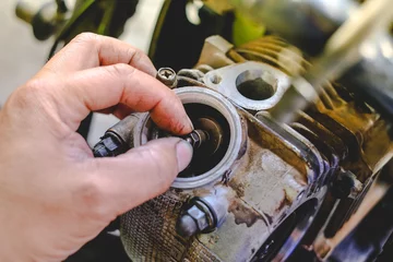 Foto op Canvas The mechanic is setting the valve on the motorcycle engine. © กอล์ฟ สแตนดาร์ด