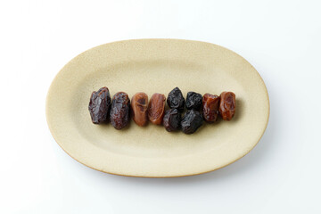 Four various Dates Fruit on Oval Plate, Ajwa, Medjool, Tunisian, Sukkari Date Fruits