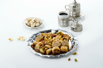 mix baklava dish or baklawa is arabic and turkish traditional sweets with pistachio , top view