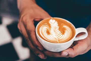 Cup of coffee latte art with coffee shop.
