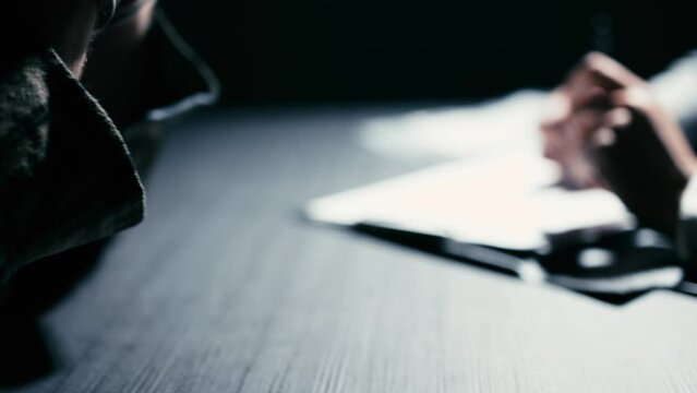 Distraught man in handcuffs hiding face in hands, crime suspect, interrogation