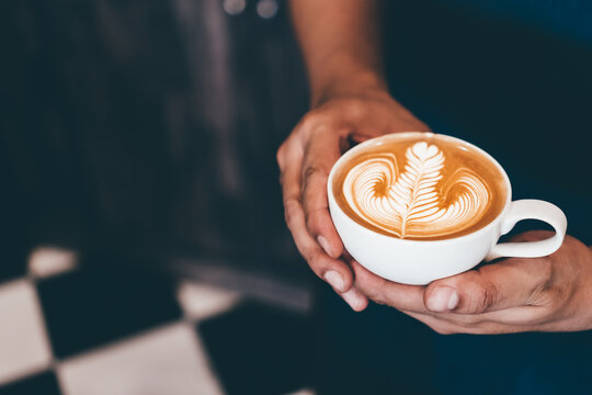 Cup of coffee latte art with coffee shop.