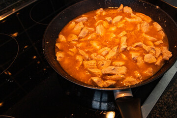 chicken meat in tomato sauce curry in frying pan cook meal fresh poultry meat portion healthy meal food diet snack on the table copy space food background rustic top view