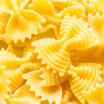 background from uncooked farfalle pasta pieces