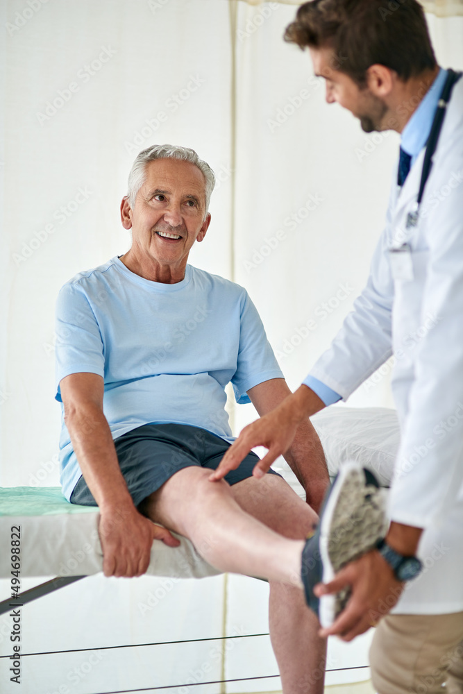 Poster his check ups are always fun with his friendly doctor. cropped shot of a happy senior man attending 