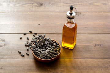 Sunflower oil in bottle with seeds. Cooking oil background