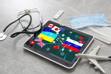 Ukrainian and Russian flag on a tablet and inscription attack. The concept of news in Ukraine and...