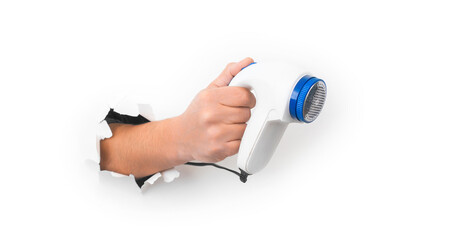 Lint remover machine in hand on white background isolation