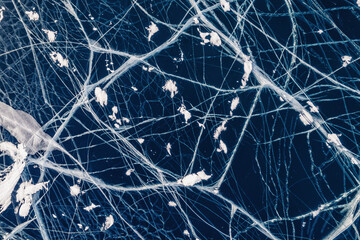 Winter lake Baikal, Abstract background texture of blue ice with cracks, aerial top view