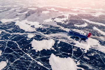 Obraz premium Hovercraft rides on clear ice of Lake Baikal winter