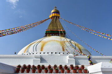 wisdom eyes at  Bouddhanath  stupa and colourful prayer flags with blue sky at Katmandu nepal