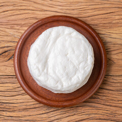 Frescal cheese, typical brazilian fresh white cheese over wooden table