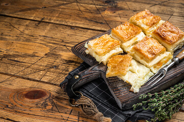 Delicious Turkish Tray pastry, Su boregi with cheese. Wooden background. Top view. Copy space