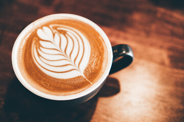 coffee latte art on wood table, relax time, cafe barista art top view.