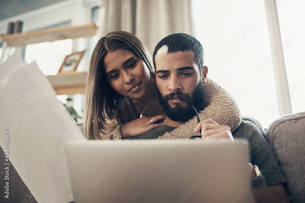 Poster turning budgeting time into bonding time. shot of a young couple using a laptop while going through 