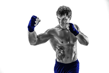 Studio shot of silhouette kickboxer who practicing uppercut on white background. Blue sportswear 