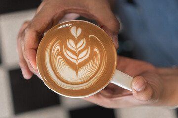 coffee latte art on wood table, relax time, cafe barista art top view.