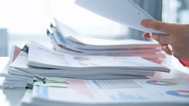 Businesswoman Accountant Sorting  Stack Of Documents For Business Report. Financial And Paperwork Concept