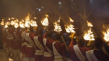 Group Of Priest Holding Fire Lamps In Ganga Rivershore During Aarti At Triveni Ghat In Rishikesh, India. Medium Shot