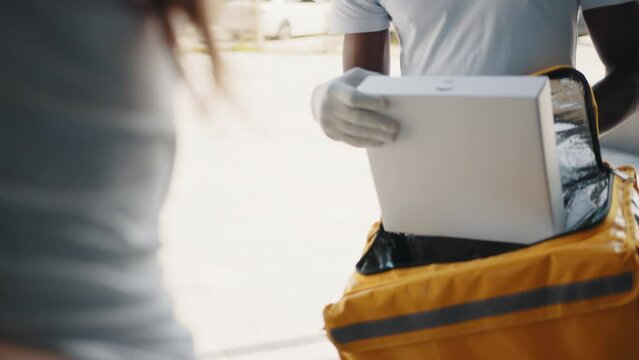Close-up hand of people carry, send or give postal mail to lady at door house in secure pickup service job from online shop store SME e-commerce with omni channel fast express post