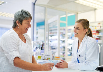 Reviewing the instructions with her customer. Shot of a young pharmacist assisting a customer.
