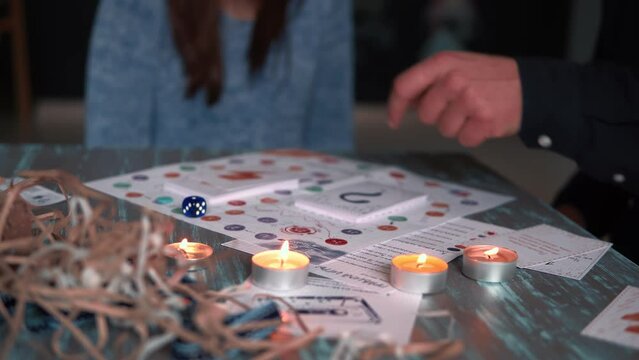 Fun bonding time at home, close-up happy romantic couple throw dice, enjoy playing boardgames together slow motion.