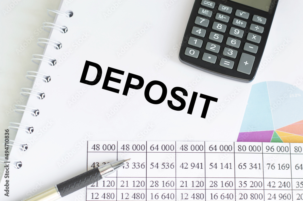 Poster deposit text on a notepad on a table with reports, calculator and pen, business and finance concept
