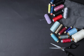 Colored threads and needles. Everything you need for sewing. Several spools of thread. Sharp...
