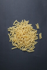 Pasta isolated on a black background. Pasta, spaghetti, shells, tubes.