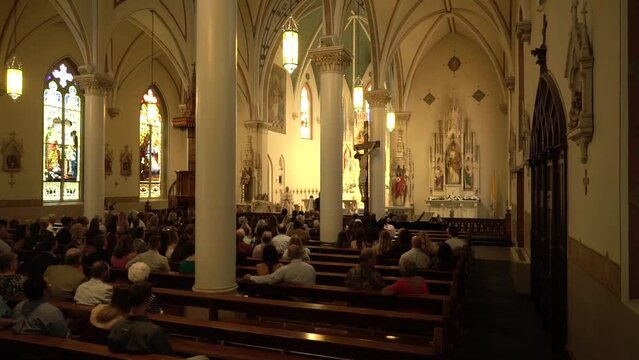 People gather in a church for a wedding.