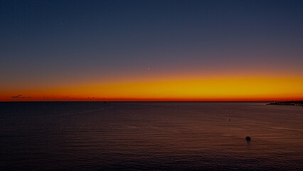 Obraz premium huge sunset with a golden hour over sea from sky